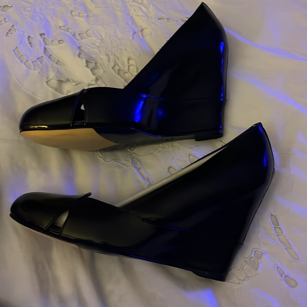 New Elegant Black Leather shoes. Sleek polished design with cutouts at sides.